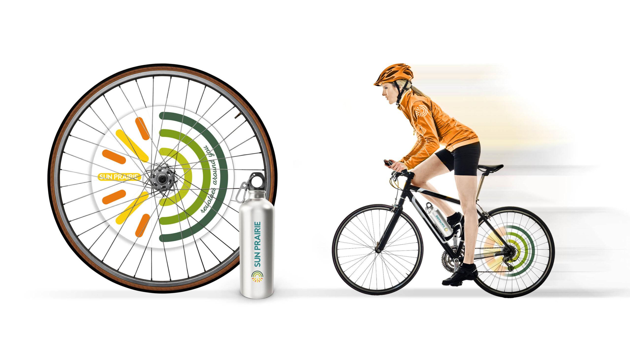 woman on bicycle with wheel featuring a revolving Sun Prairie logo